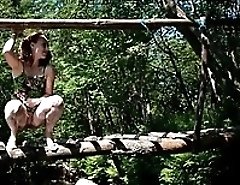 Charming red-haired teen cutie pees off the bridge