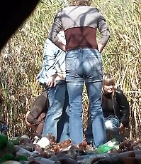 A group of older women pissing outdoors
