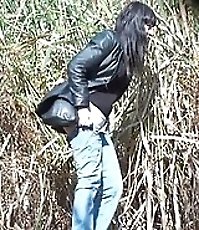 Chick wets trouser leg while pissing