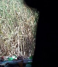 Unaware women chat while pissing outdoors