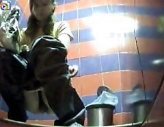 Two babes pissing in a spycammed beach toilet