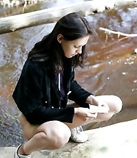 Spy busts a hot young chick pissing into the river