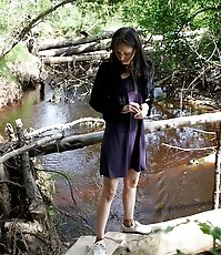 Spy busts a hot young chick pissing into the river