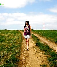 Emo chick pissing in the middle of a country road