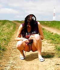 Emo chick pissing in the middle of a country road