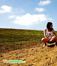 Playful teenage cutie takes a leak under the sun
