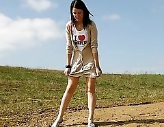 Playful teenage cutie takes a leak under the sun