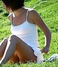 Hidden cam upskirt. Beatiful brunette in white caught
