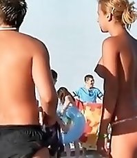 Topless bikini girl talking to the guy paying no attention he is staring at her boobs