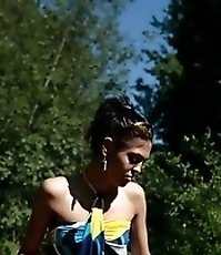 Skinny ravenhead urinating next to a picnic table