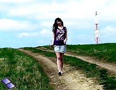Brunette ho peeing in the middle of a country road