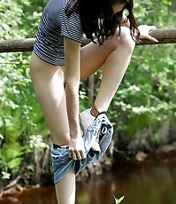 Leggy tart peeing from run-down bridge in country