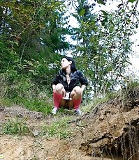 Naughty brunette tart takes a leak in the woods