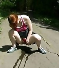 Adorable redhead tinkles on deserted country road