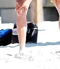 Bikini doll doing blowjob on beach