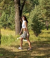 Sexy slim nature-admirer whizzing under a tree