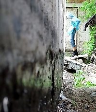 Cute gal pulls her jeans down to urinate outdoors