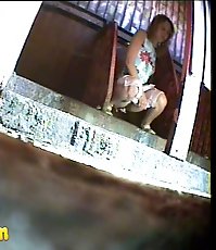 Blonde chick emptying her bladder in park toilet