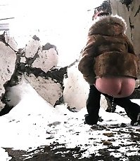 Winter voyeur shooting of a girl peeing in a nook