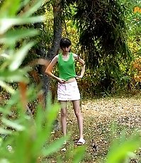 Little babe takes a leak in the nearby bushes