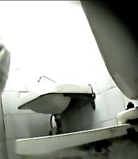 Young sexy lady takes a plentiful whiz in a WC