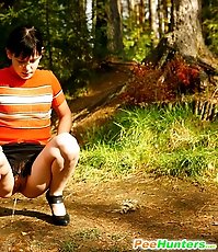 Careless puss peeing on a beautiful forest glade