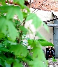 Sexy blondie empties her bladder behind a building