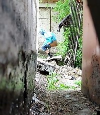 Cute gal pulls her jeans down to urinate outdoors