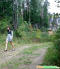 Spying after a brunette kitty pissing in the woods