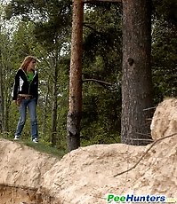 Beautiful teen plays watersports on a quiet forest glade