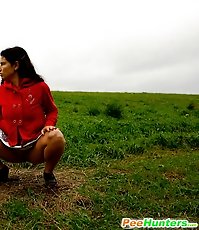 Barely legal brunette tinkling alone on a field