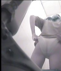 Raunchy hottie urinates onto spy cam in public loo