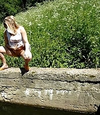 Playful little ho does water sports on lake shore