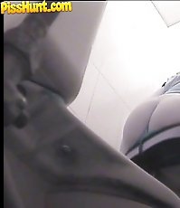 Raunchy hottie urinates onto spy cam in public loo