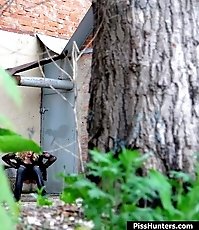 Sexy blondie empties her bladder behind a building
