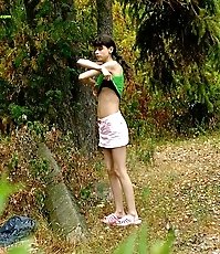 Little babe takes a leak in the nearby bushes