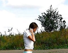 Stunningly beautiful leggy doll weeing outdoors
