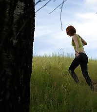 Babe tinkles on a rock in the middle of a field