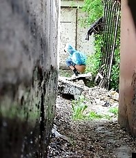 Cute gal pulls her jeans down to urinate outdoors