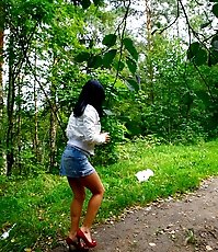 Hot brunette shows smoothie while pissing alfresco