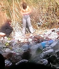 Two unsuspecting chicks make a pee in the open air