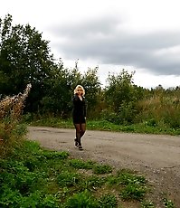 Stockinged blonde makes water on a quiet park alley