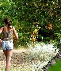 Young swarthy babe pisses sitting on the rock