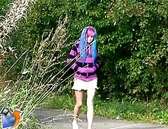 Young girl with crazy hairstyle pissing outdoors