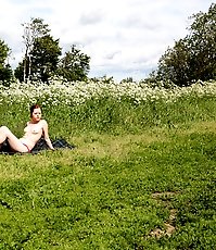 Nude sunbather squats down to take a leak in park