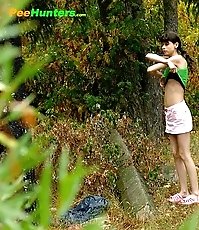 Little babe takes a leak in the nearby bushes