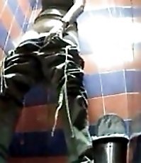 Peek at girl taking her baggy pants off and peeing