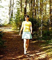 Cute brunette squats down to take a leak in forest