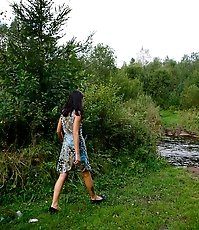 Spying after a cute babe peeing on the river beach