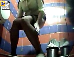 Two chicks emptying her bladder in public toilet